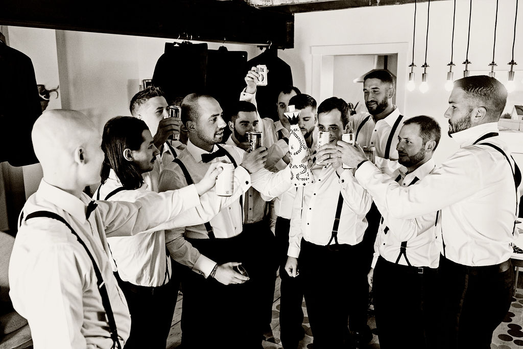 Groomsmen toasting while they are getting ready for a wedding