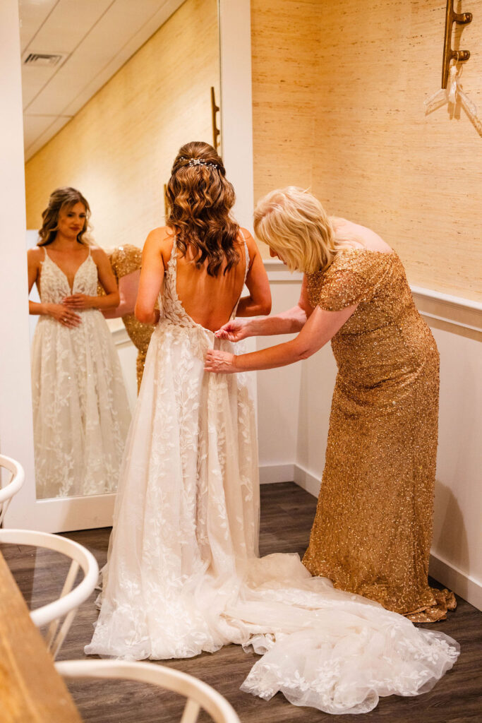 Bride getting in her dress at the Newport Beach House in Newport, RI