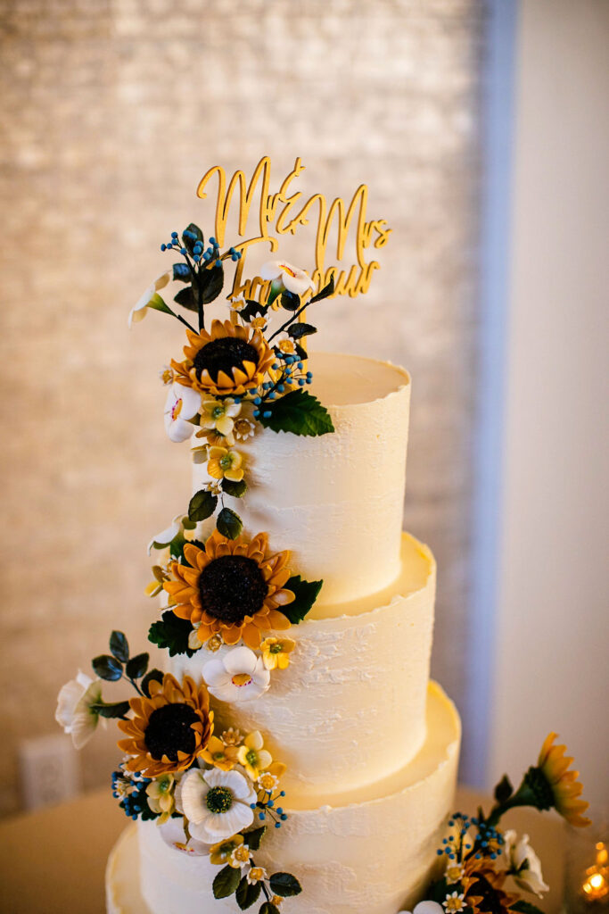 Reception space with sunflowers, navy blue linens, and gold accents at Belle Mer wedding in Newport, RI 