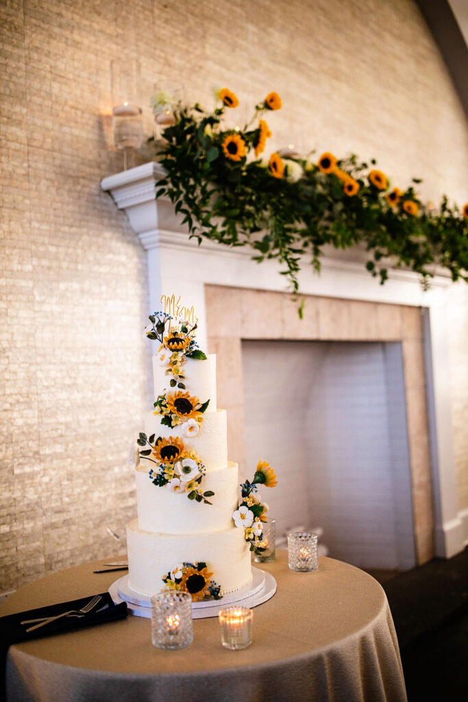 Reception space with sunflowers, navy blue linens, and gold accents at Belle Mer wedding in Newport, RI 