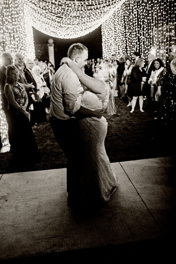 Bride and groom having their exit under Ormonde Productions light installation at Belle Mer wedding in Newport, RI 