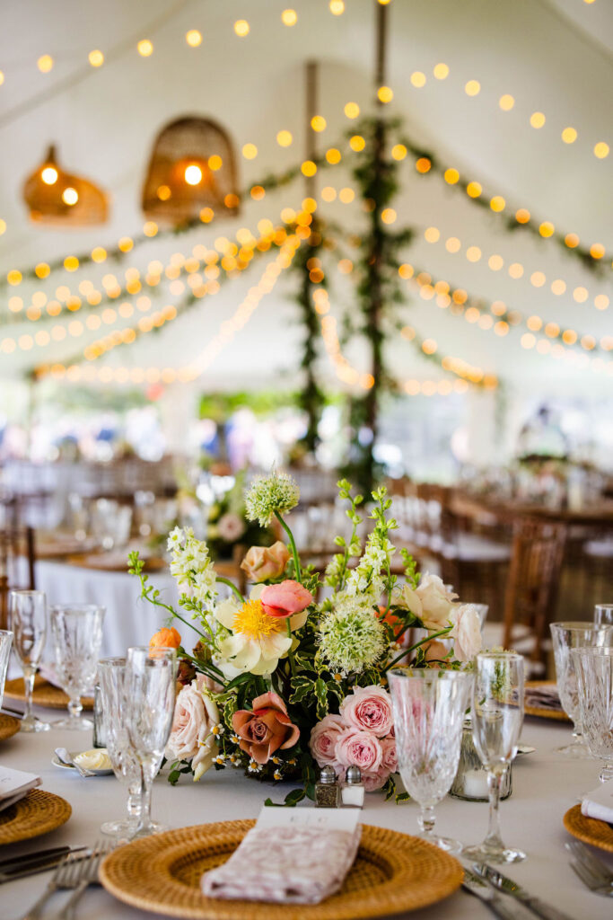 Reception tent with ratan lanterns and greenery at Mount Hope Farm wedding