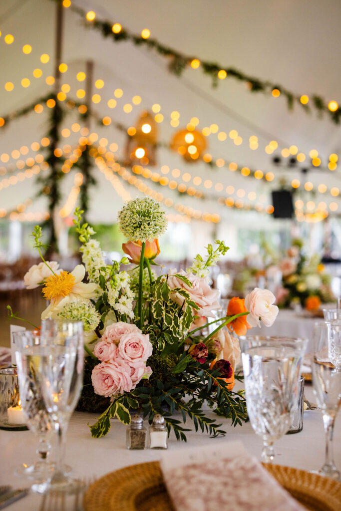 Reception tent with ratan lanterns and greenery at Mount Hope Farm wedding