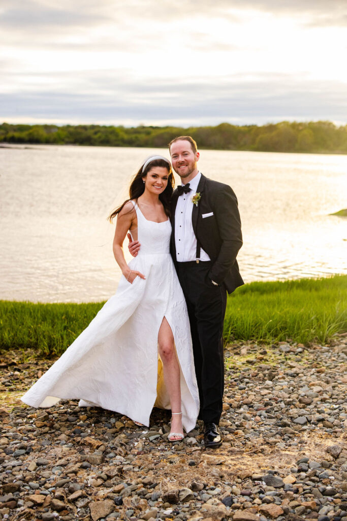 Bride and Groom by the water at sunset at Mount Hope Farm wedding