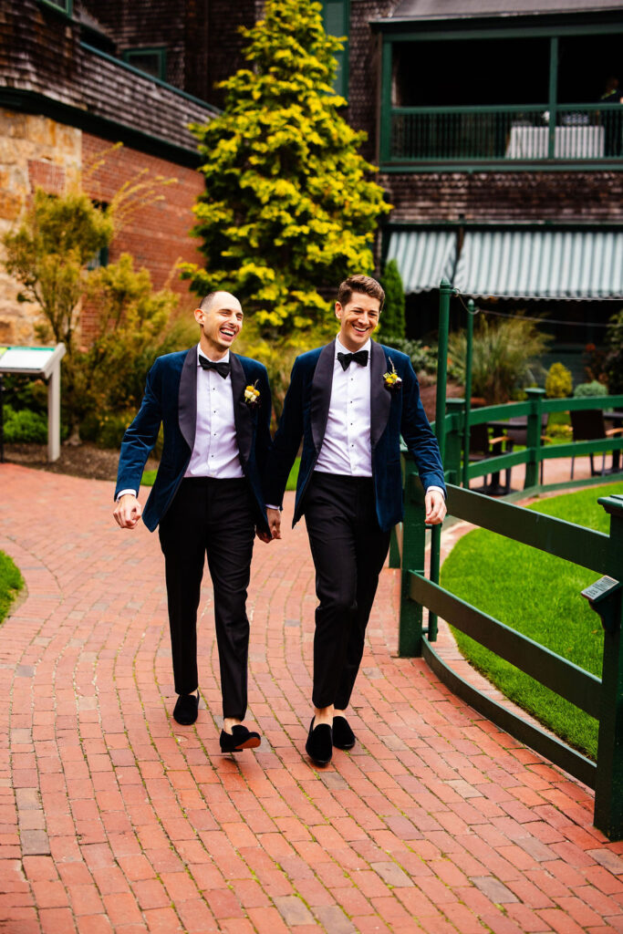 Grooms posing on the green at their Tennis Hall of Fame Wedding in Newport, Rhode Island