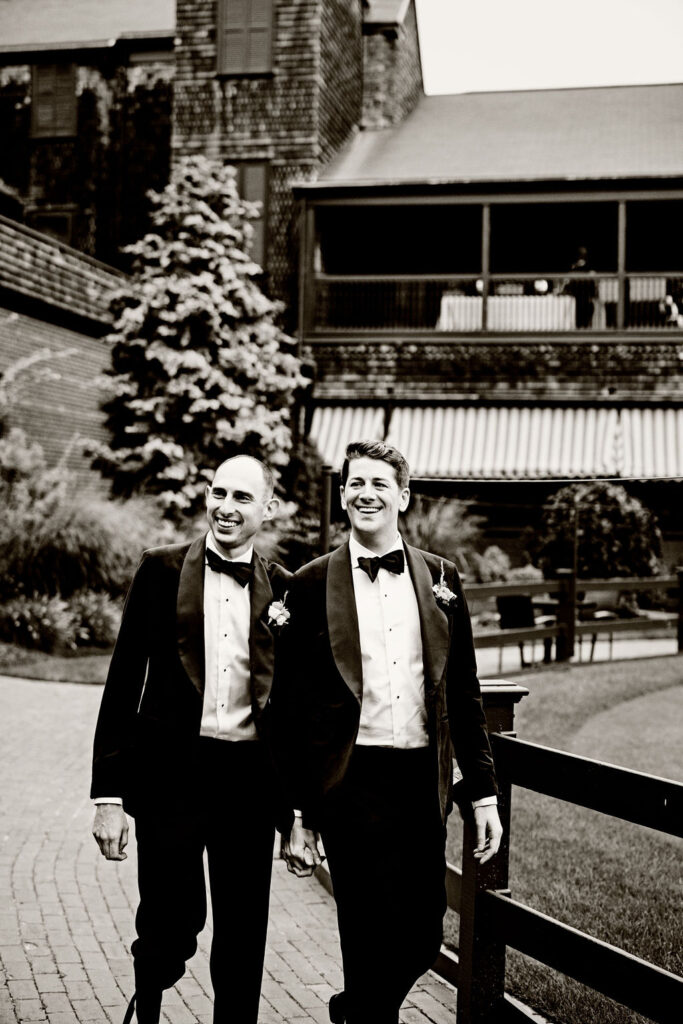 Grooms posing on the green at their Tennis Hall of Fame Wedding in Newport, Rhode Island