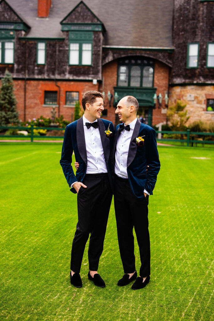 Grooms posing on the green at their Tennis Hall of Fame Wedding in Newport, Rhode Island