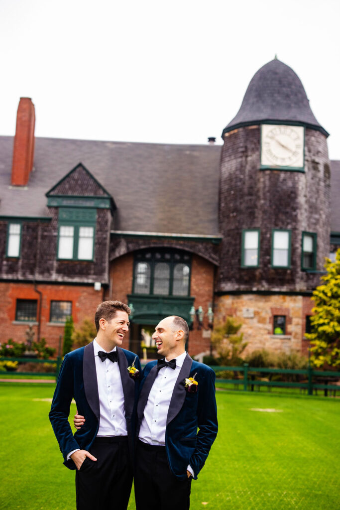 Grooms posing on the green at their Tennis Hall of Fame Wedding in Newport, Rhode Island