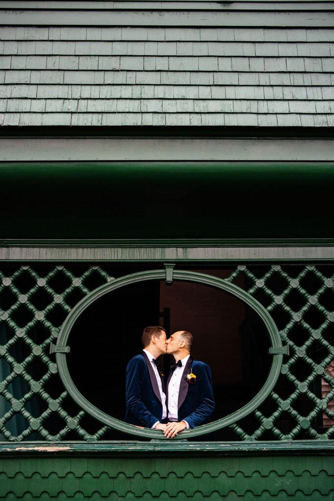 Grooms posing on the green at their Tennis Hall of Fame Wedding in Newport, Rhode Island