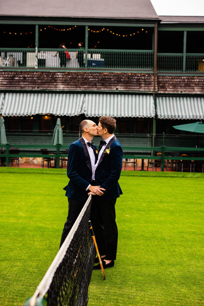 Grooms posing on the green at their Tennis Hall of Fame Wedding in Newport, Rhode Island