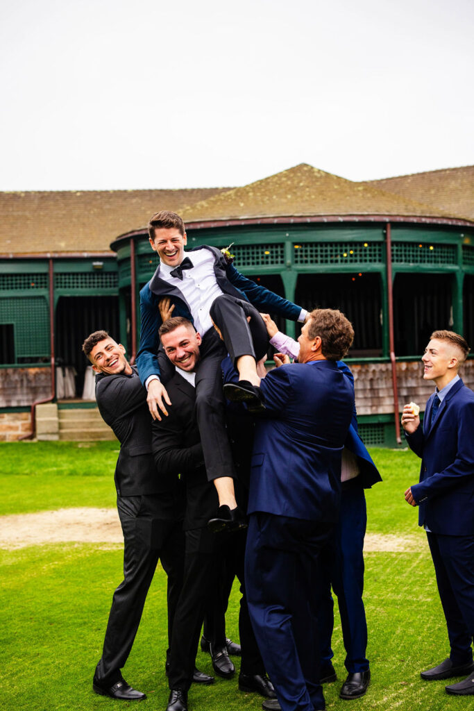 Grooms posing on the green at their Tennis Hall of Fame Wedding in Newport, Rhode Island