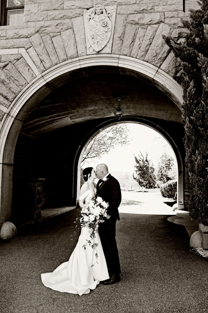 Bride and groom under arch at Oceancliff wedding in Newport Rhode Island Wedding Photographer