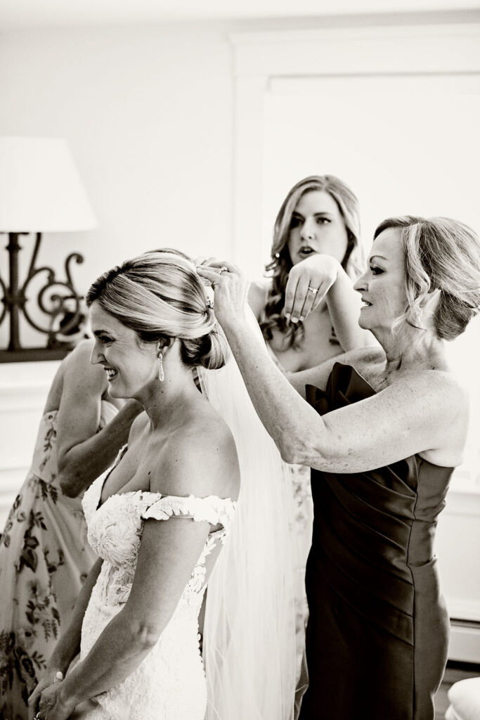 Bride with her bridesmaids getting ready for the wedding at the Belle Mer Island House in Newport, RI.