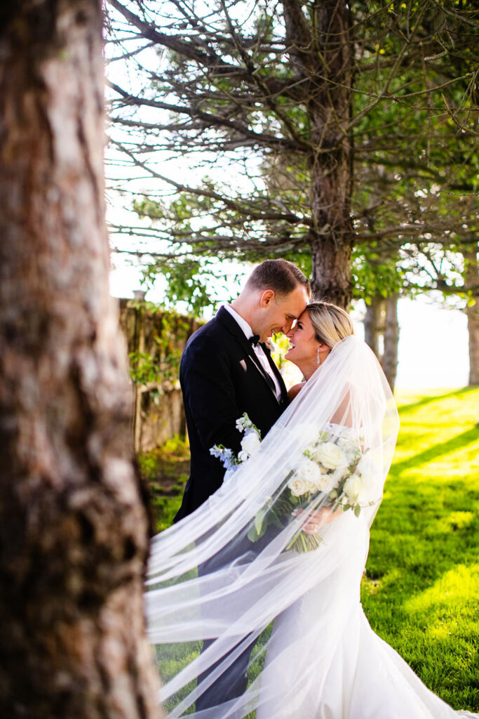 Bride and Groom posing for formal photos at Belle Mer Island House in Newport, RI.