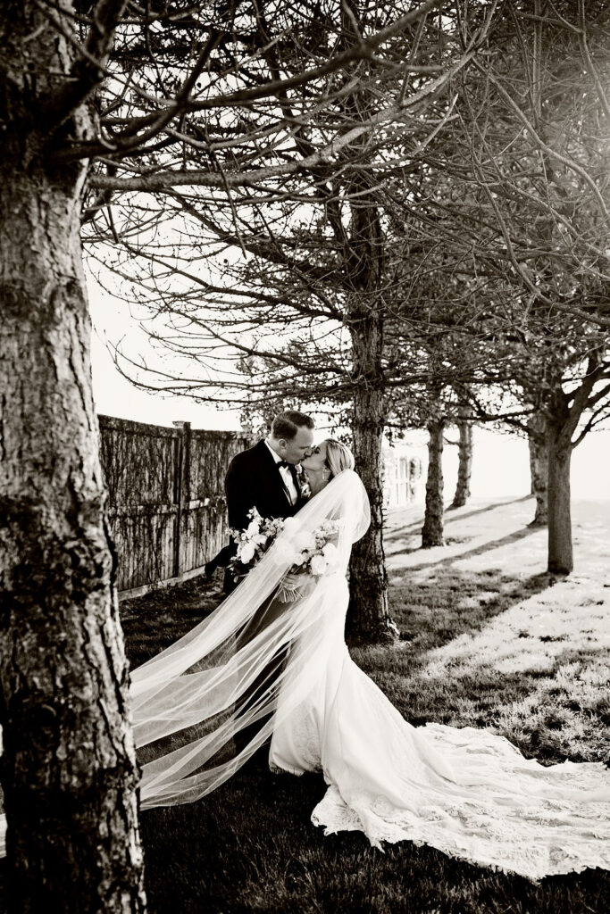 Bride and Groom posing for formal photos at Belle Mer Island House in Newport, RI.