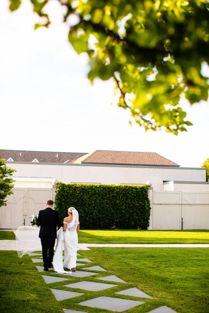 Bride and Groom posing for formal photos at Belle Mer Island House in Newport, RI.