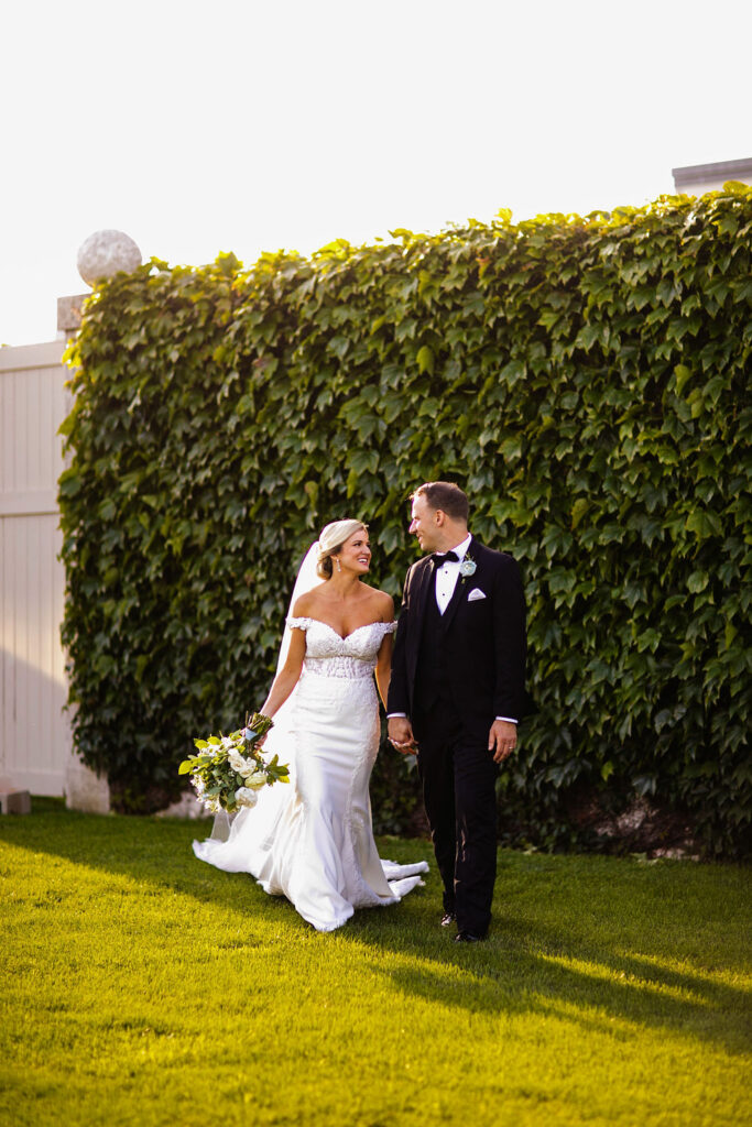 Bride and Groom posing for formal photos at Belle Mer Island House in Newport, RI.