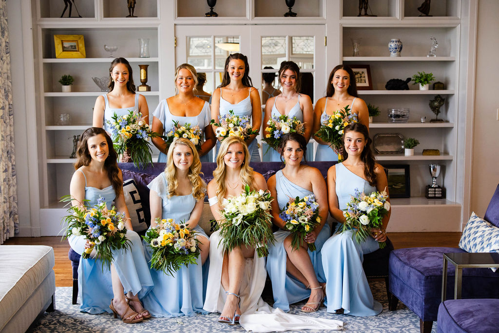 Bridesmaids posing in front of the bookshelves at Rhode Island Country Club