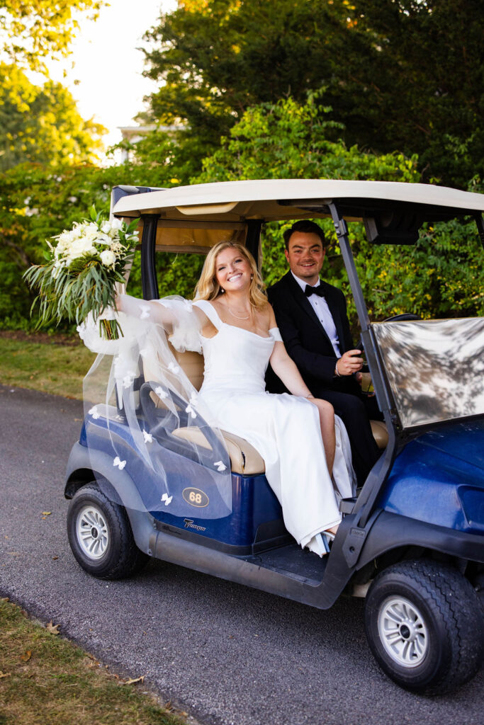 Bride and Groom in gold cart at Rhode Island Country Club