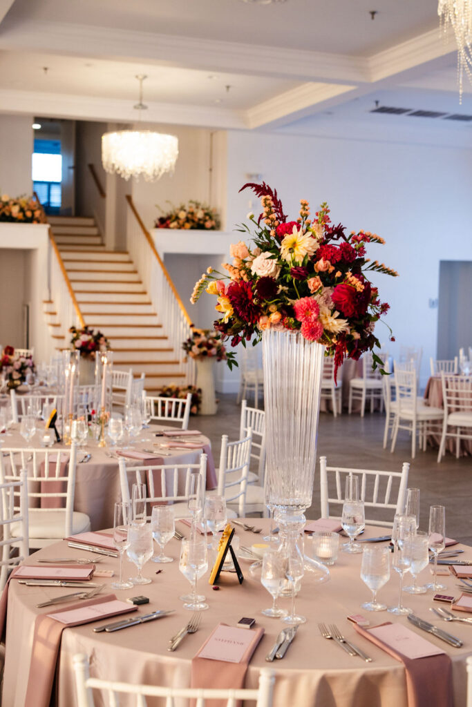 Wedding details featuring dark pink, maroon and white florals by Plant Girl Florals at Belle Mer wedding reception 