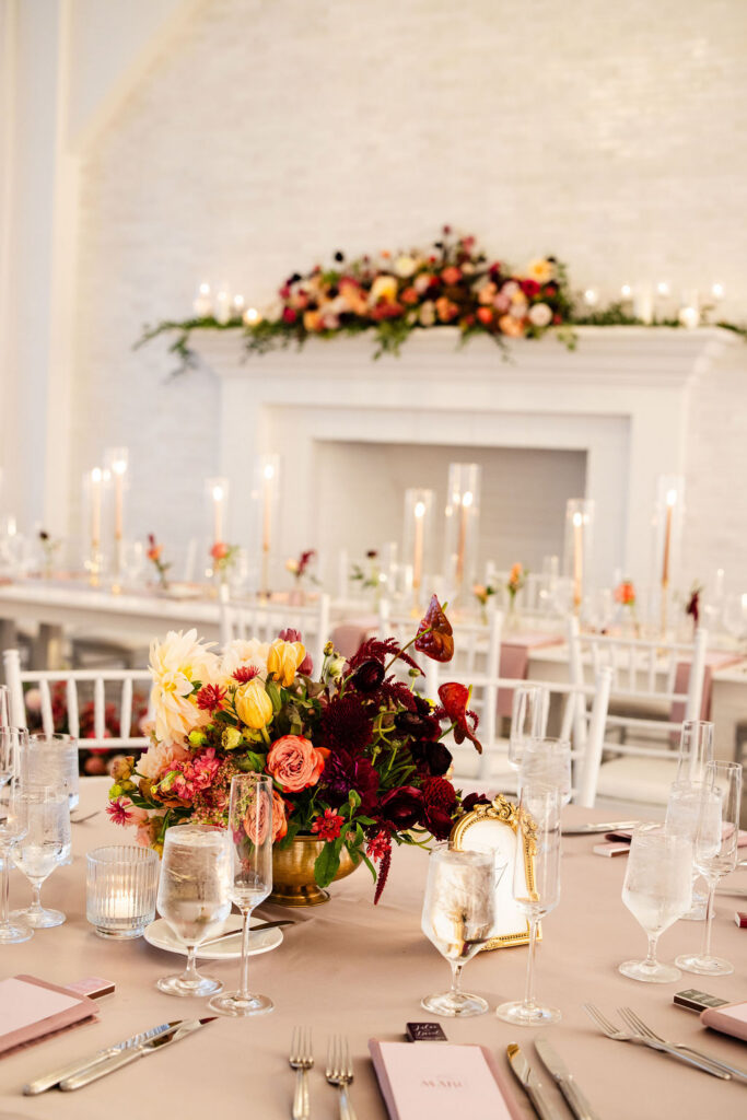 Wedding details featuring dark pink, maroon and white florals by Plant Girl Florals at Belle Mer wedding reception 