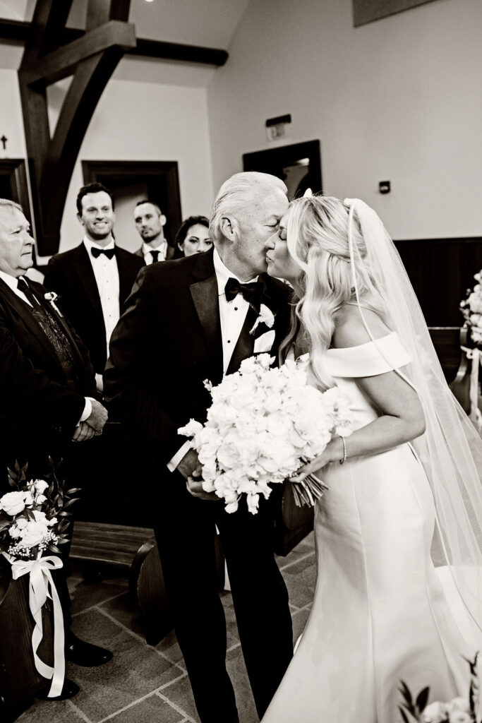 Bride and father walking down the aisle at the chapel at Salve Regina in Newport 
